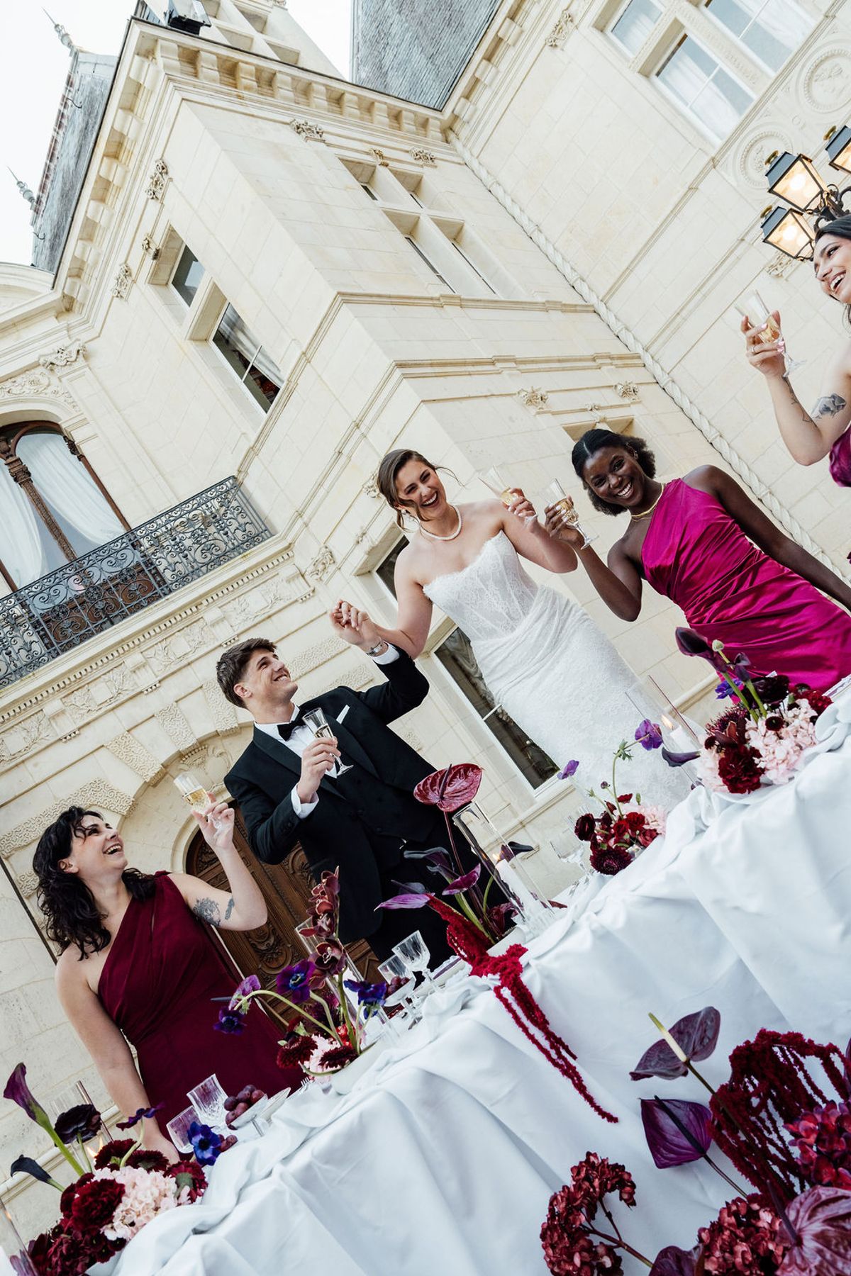 Styled shoot models Harper and Liam: the couple and a bridesmaid sharing a playful moment, Chateau de Mirambeau, spring editorial