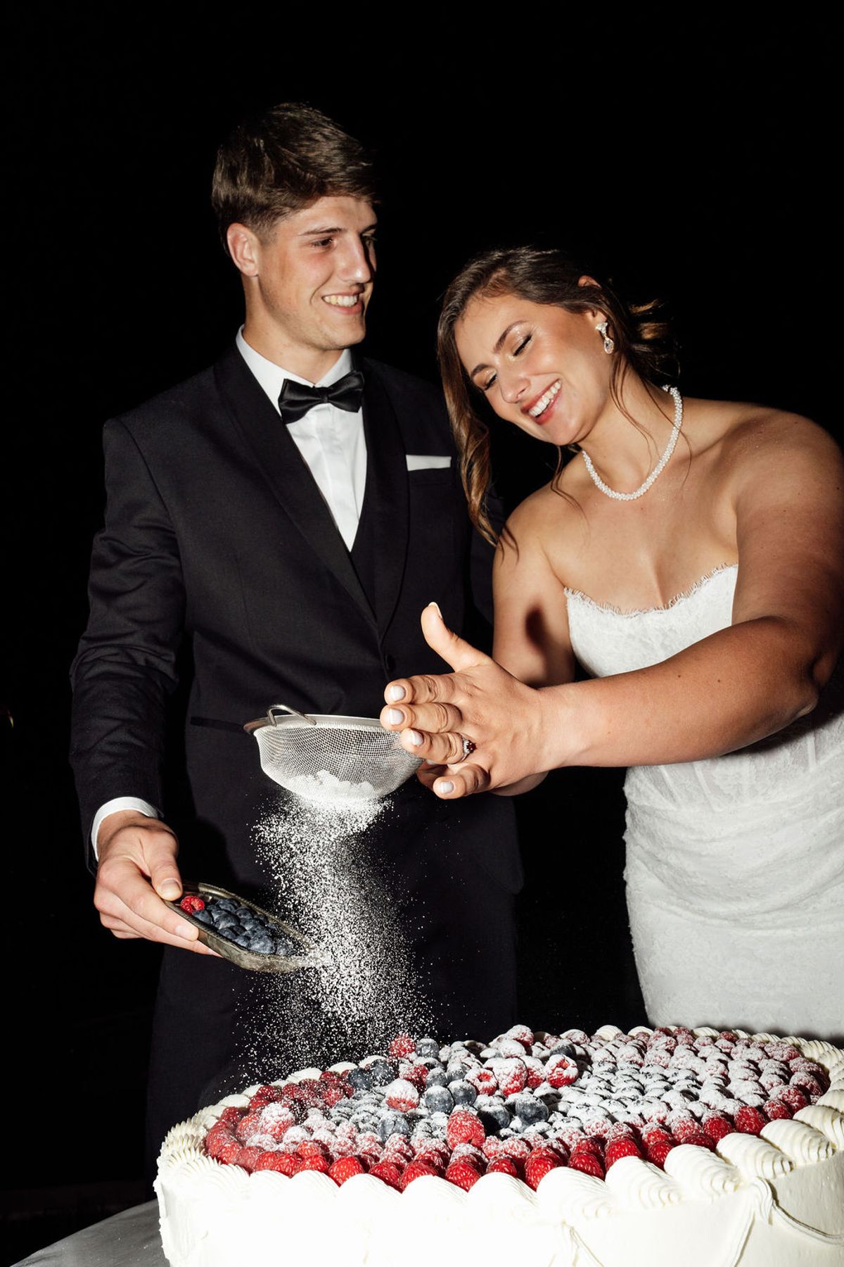 Styled shoot models Harper and Liam: the couple laughing over a sugar-dusted dessert, Chateau de Mirambeau, spring editorial