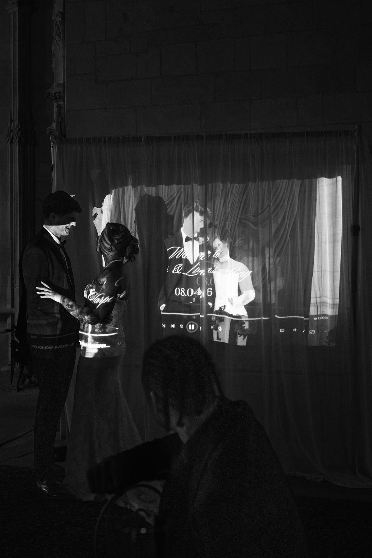 Styled shoot models Harper and Liam: the couple watching their same-day film projected onto the drapery, Chateau de Mirambeau, spring editorial