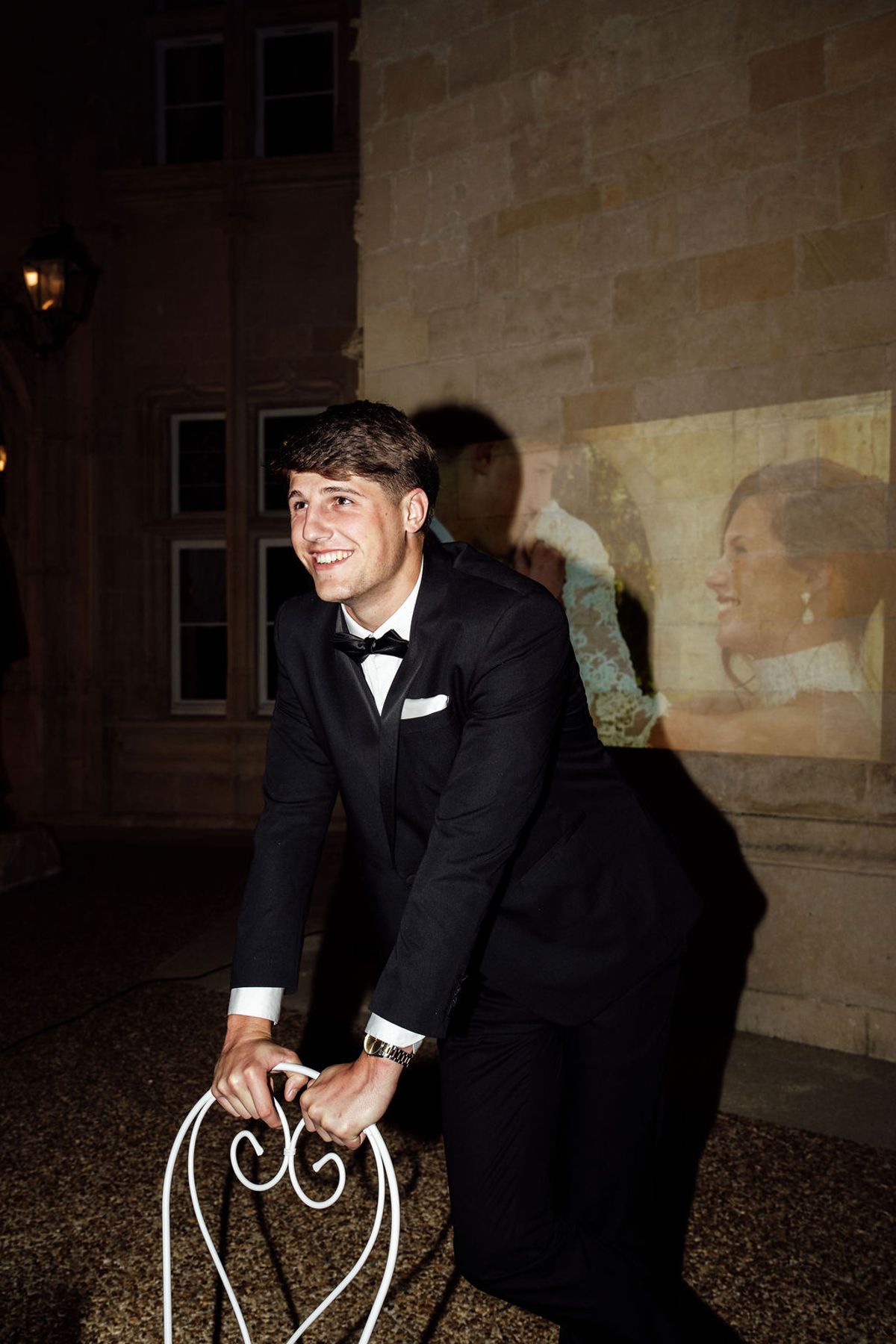 Styled shoot models Harper and Liam: the groom laughing in the evening light, Chateau de Mirambeau, spring editorial