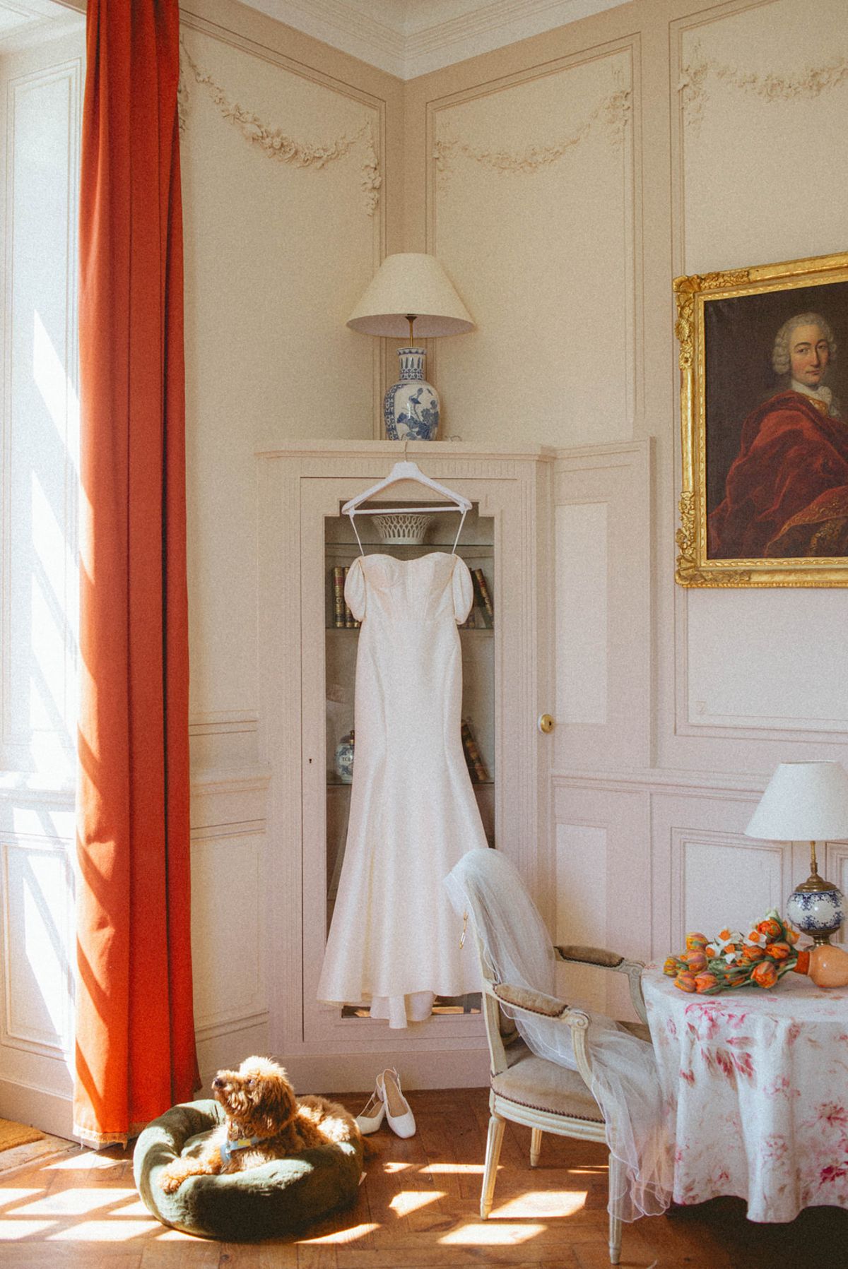 Wedding dress and dog in bridal suite at Chateau de Campet