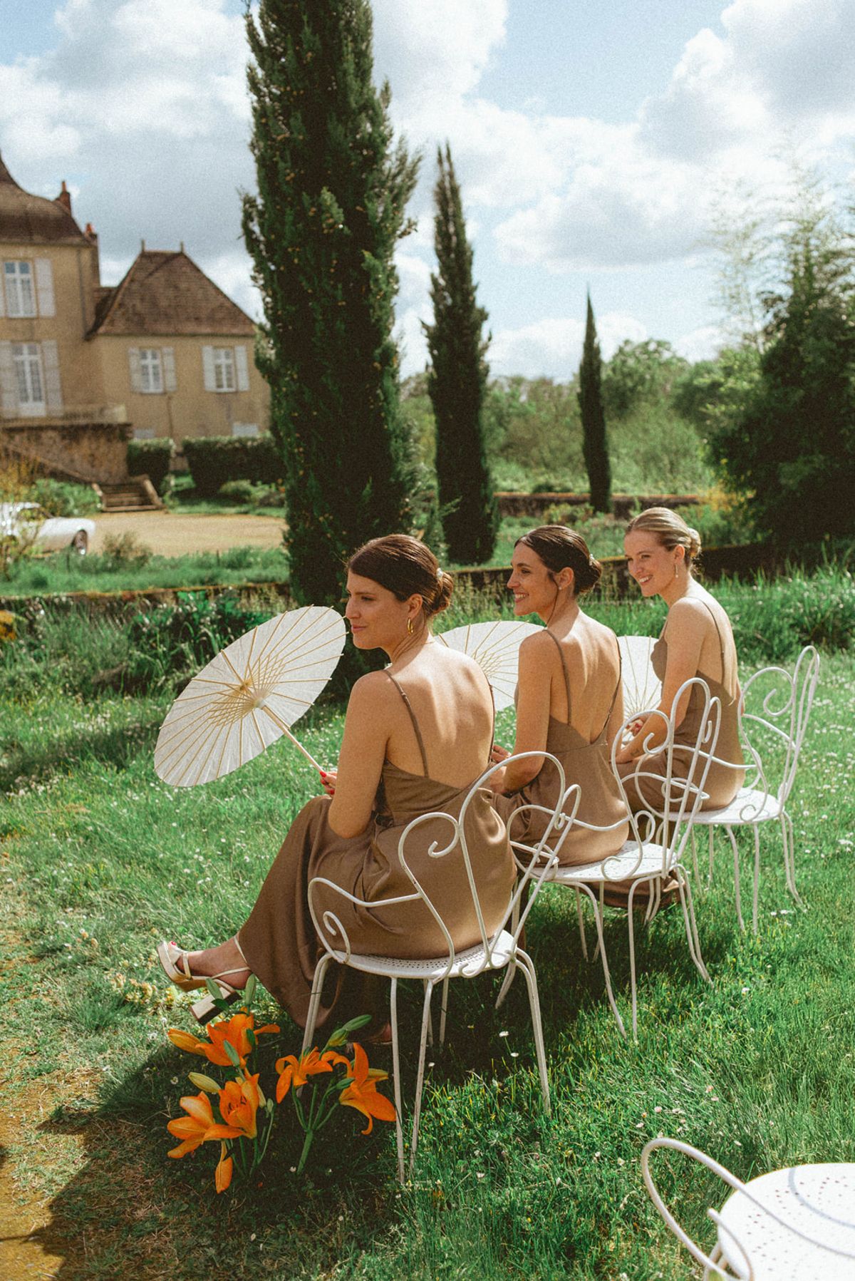 Bridesmaids with parasols at ceremony at Chateau de Campet