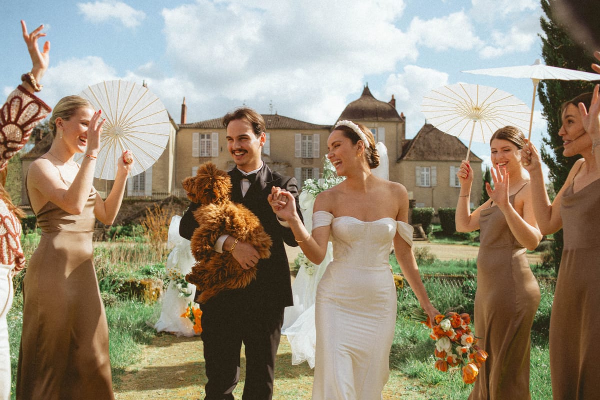 Couple with dog walking aisle at Chateau de Campet