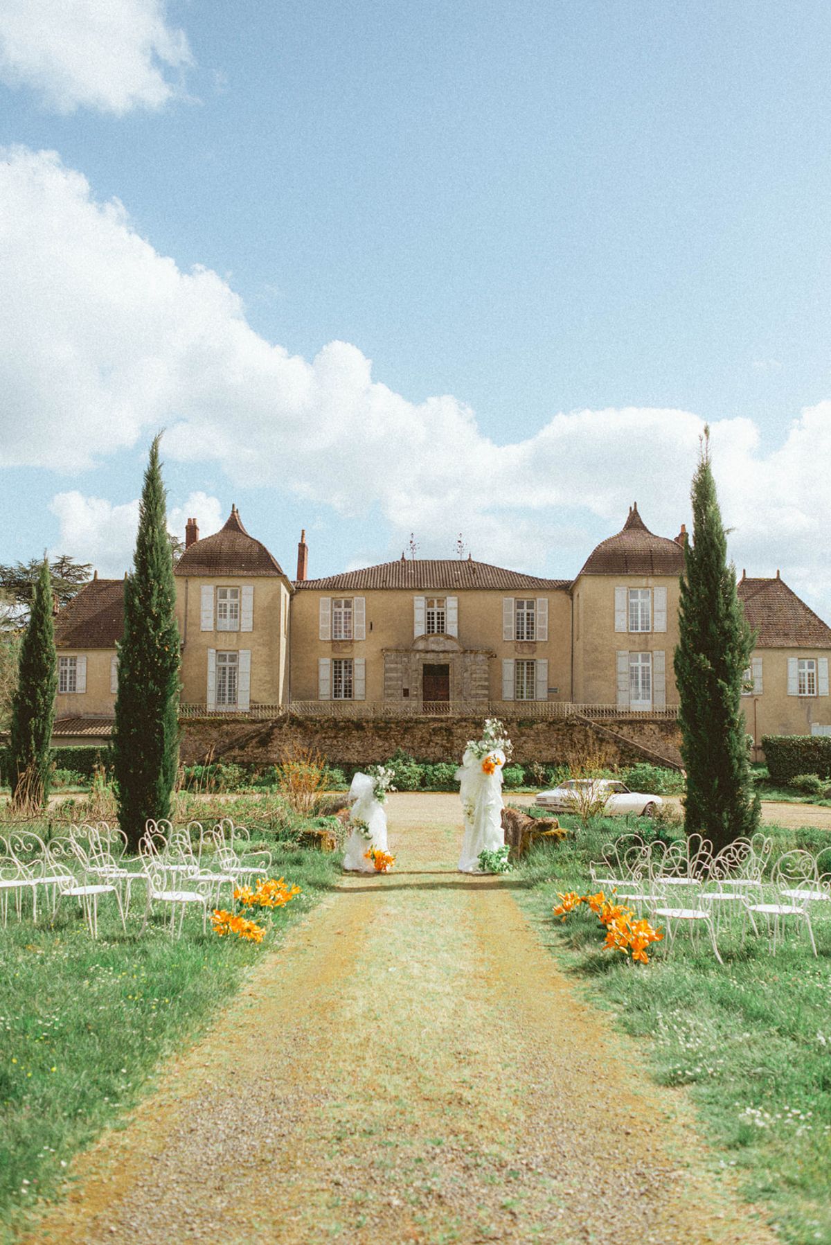 Ceremony aisle with chateau facade at Chateau de Campet