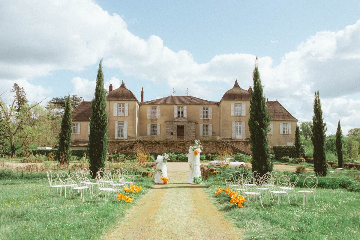 Ceremony setup with chateau backdrop at Chateau de Campet