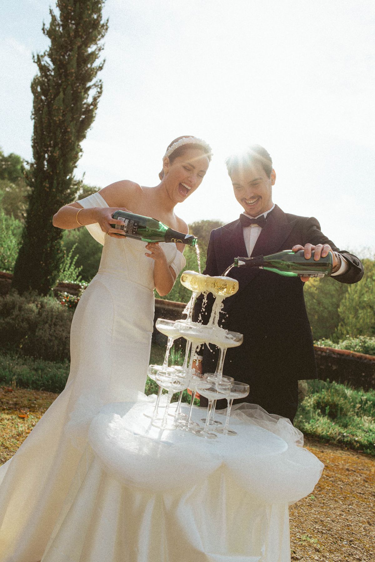 Couple pouring champagne tower close-up at Chateau de Campet