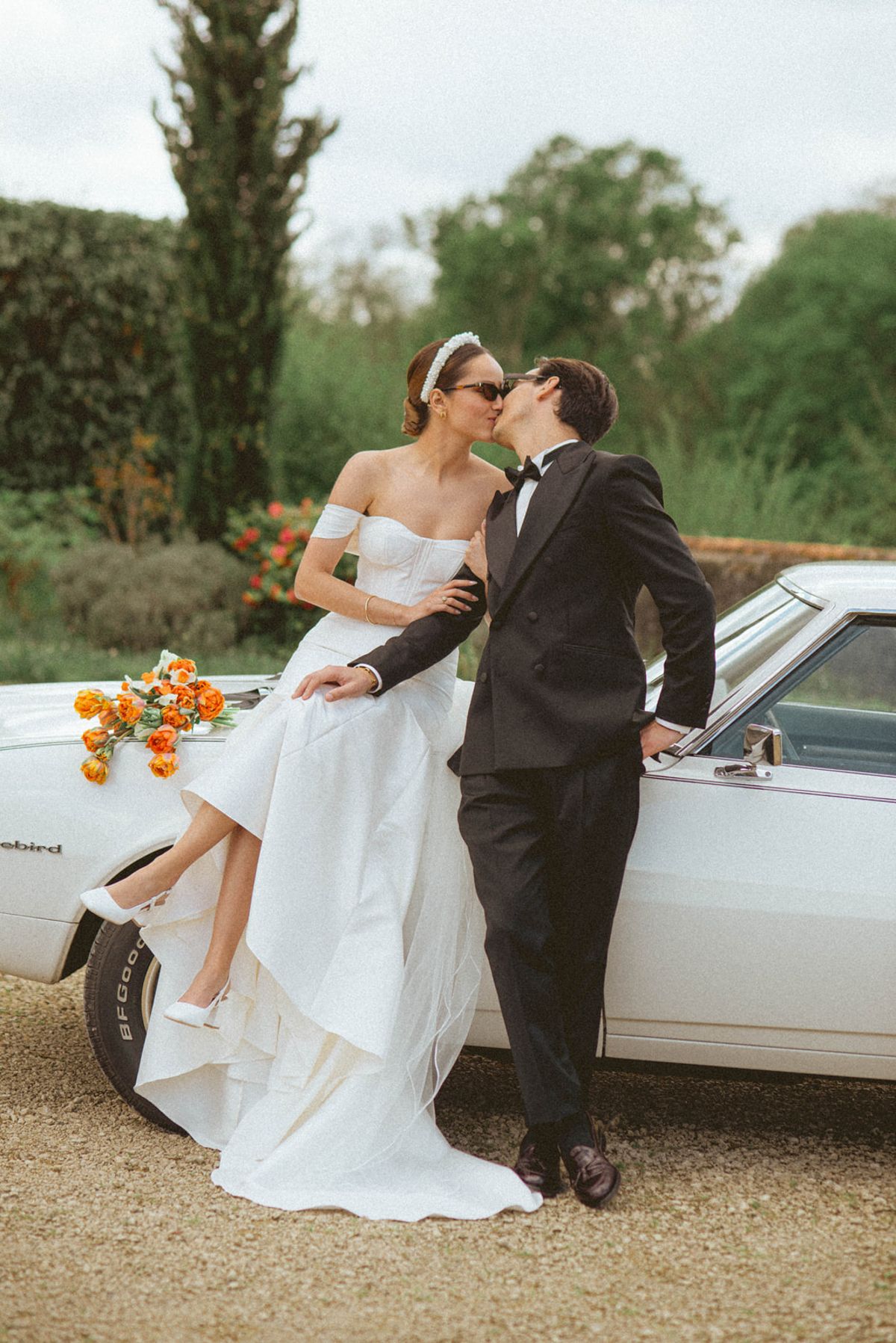 Couple kissing on vintage Thunderbird at Chateau de Campet