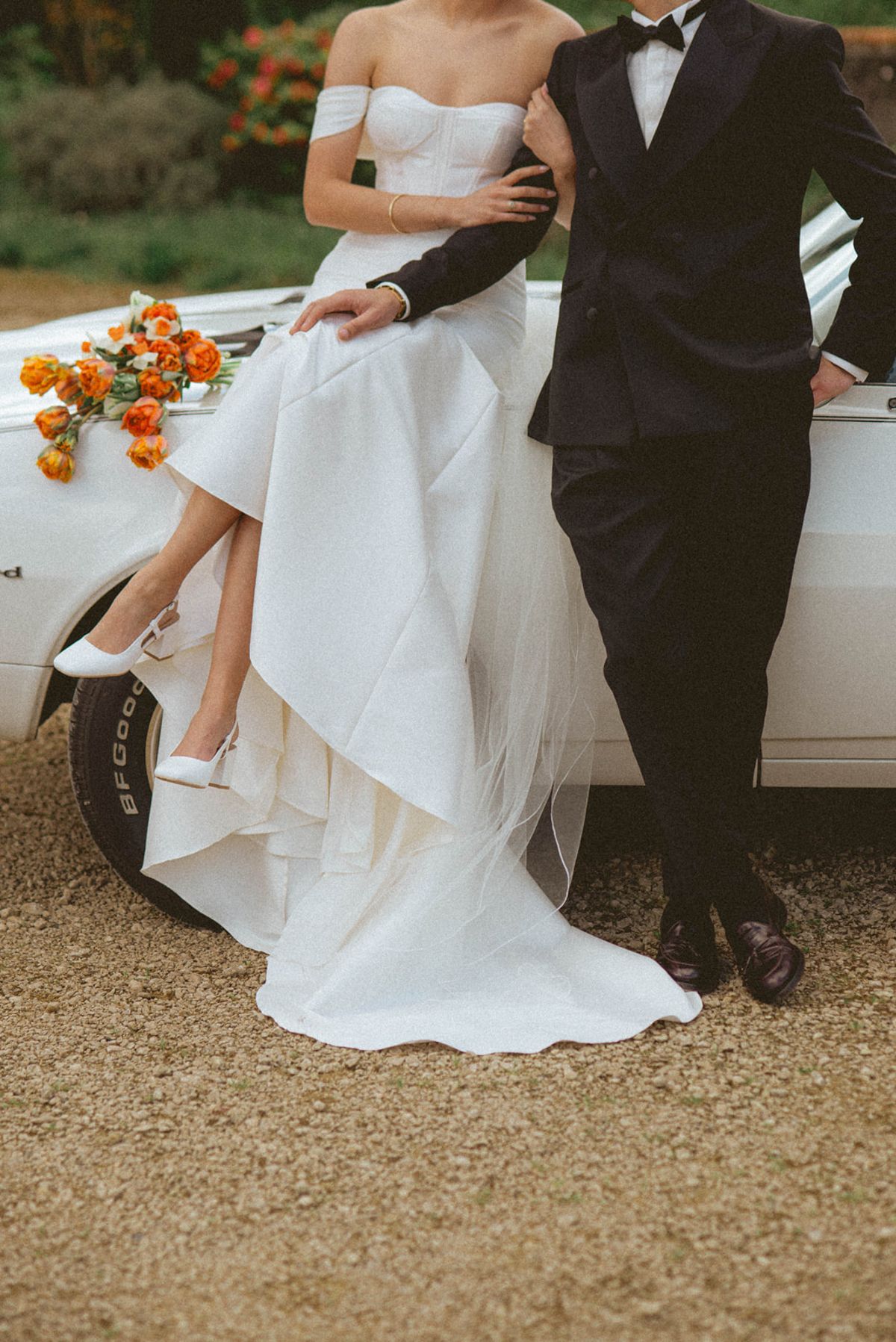 Couple on Thunderbird bonnet with bouquet at Chateau de Campet