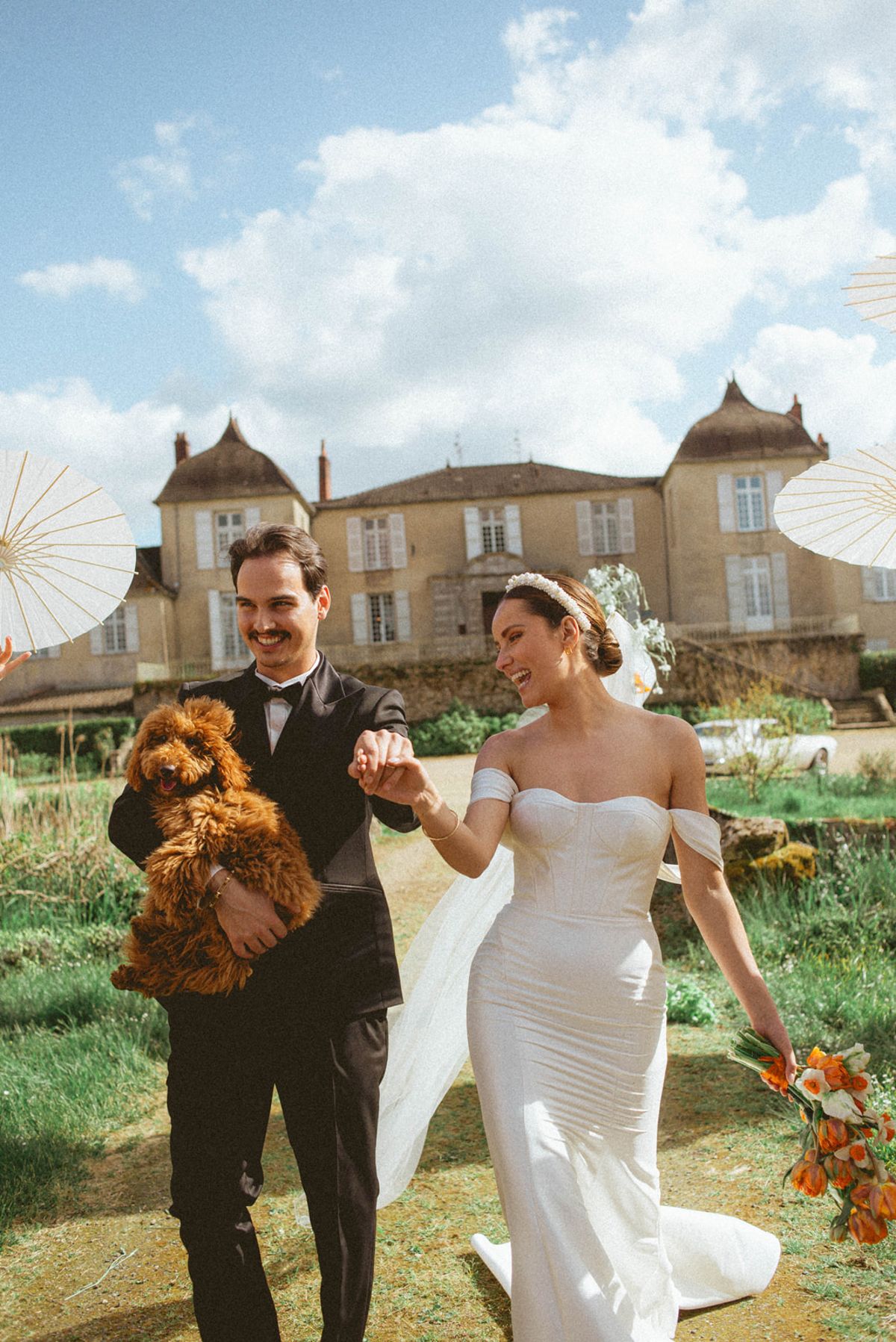 Couple with dog walking aisle at Chateau de Campet