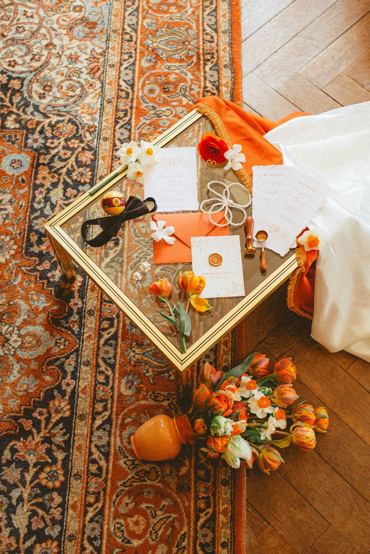 Orange stationery flat lay at Chateau de Campet