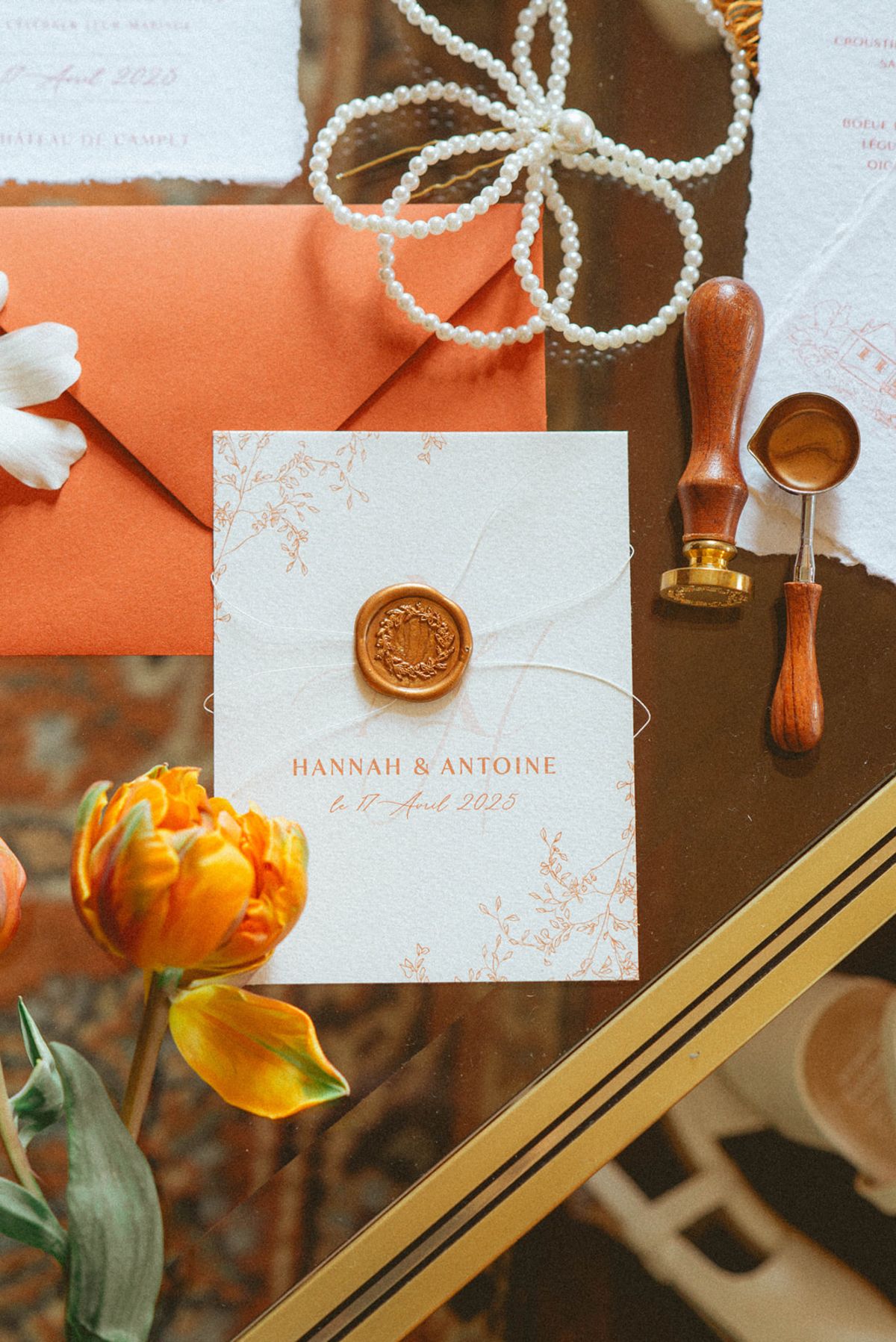 Invitation with wax seal and orange details at Chateau de Campet