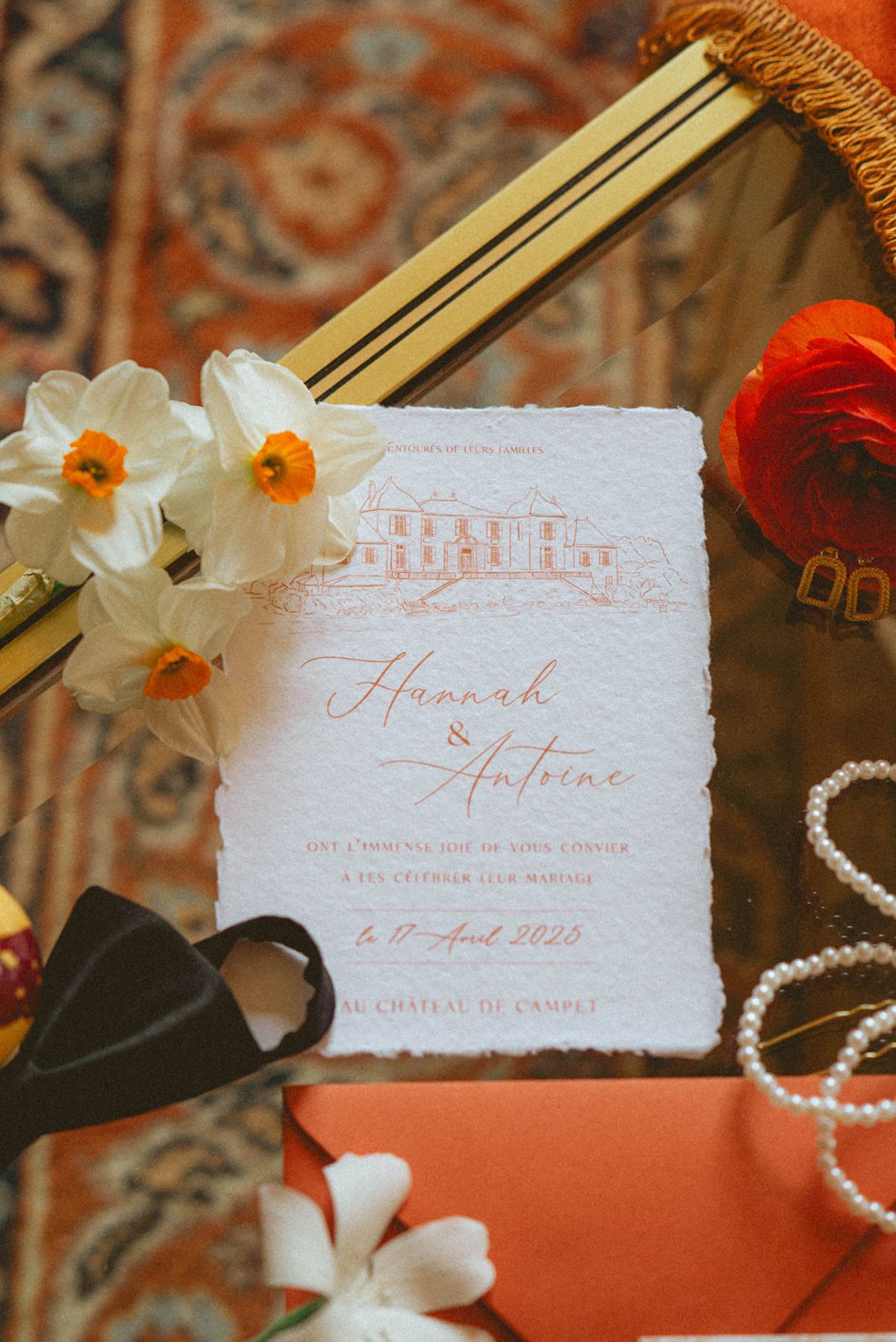 Orange-palette stationery flat lay at Chateau de Campet