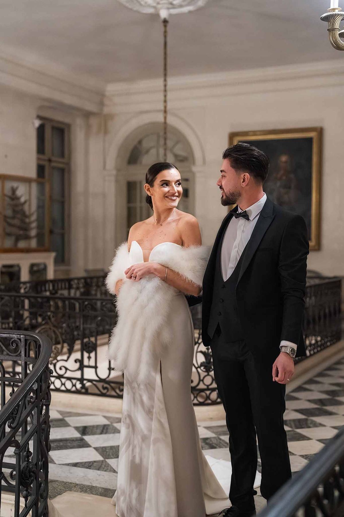 Couple on grand staircase in after-party attire at Chateau du Terral