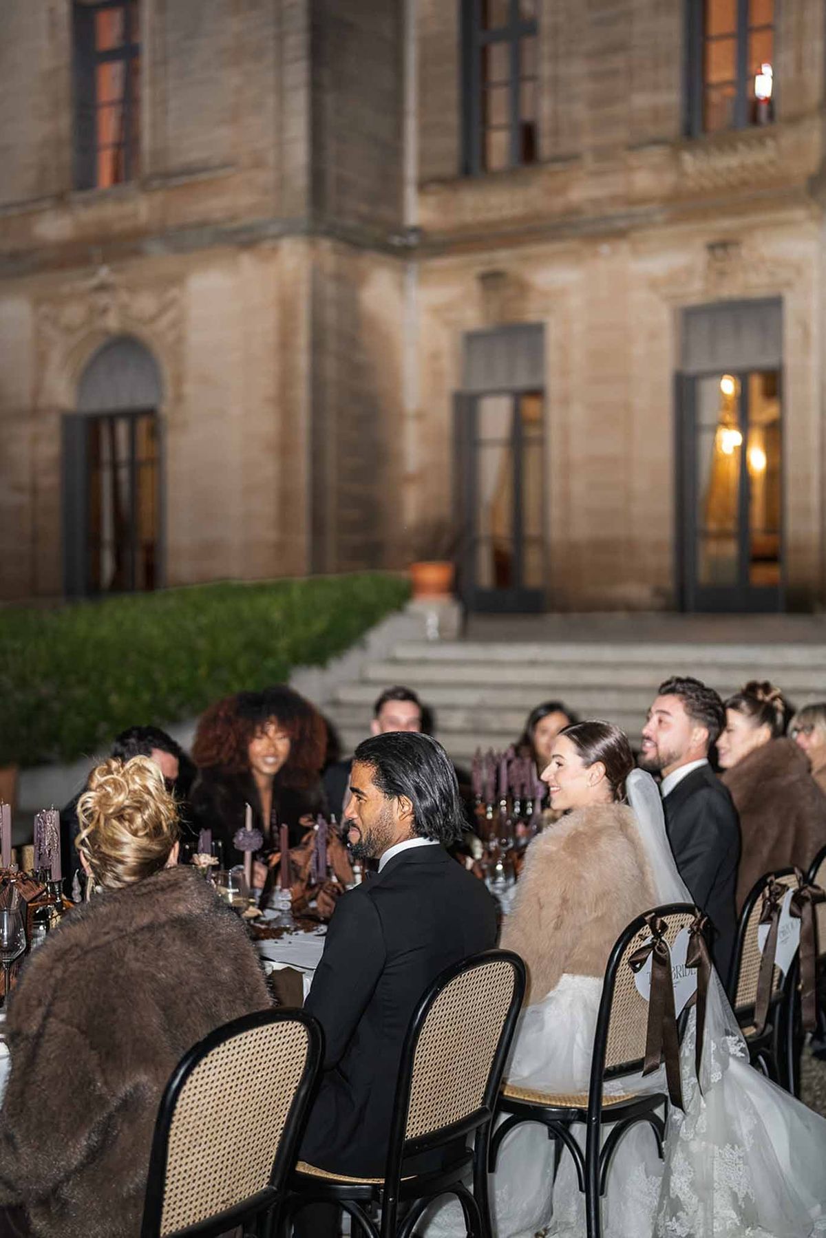 Evening reception dinner in front of Chateau du Terral with seated guests