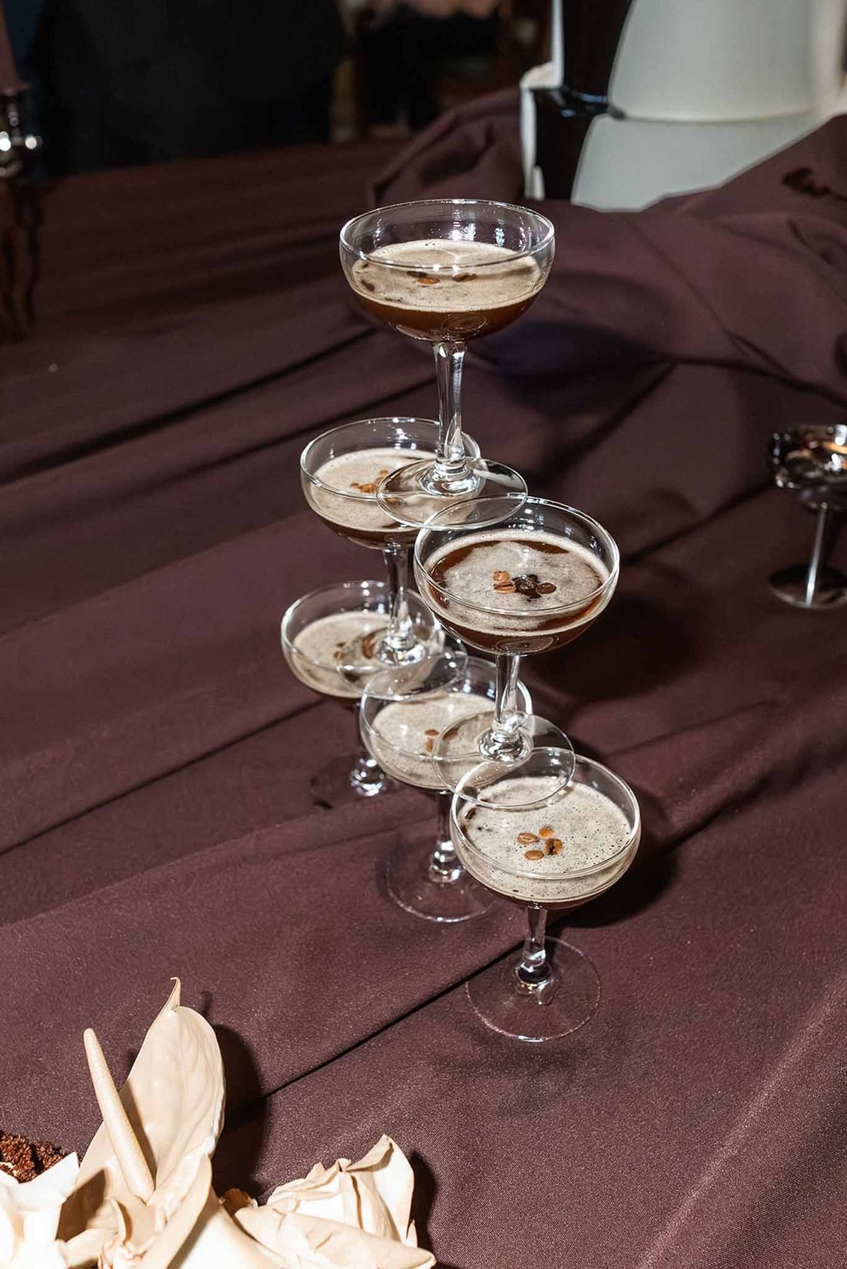 Espresso martini cocktails on dark satin at Chateau du Terral wedding reception
