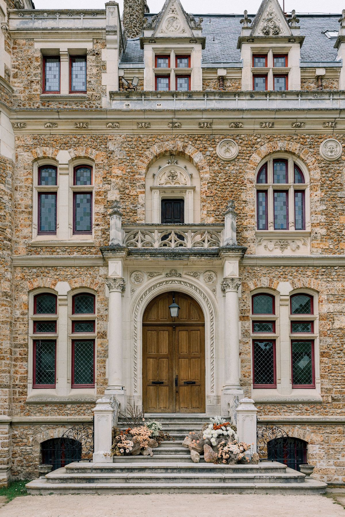 Portico entrance with floral installation at Château de Méridon, Île-de-France