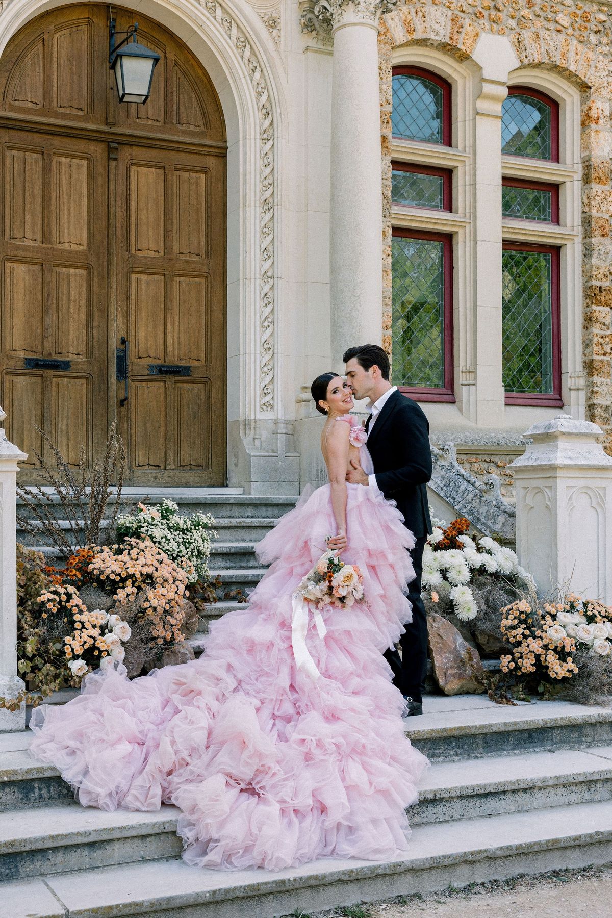 Couple embracing at portico doors at Château de Méridon, Île-de-France