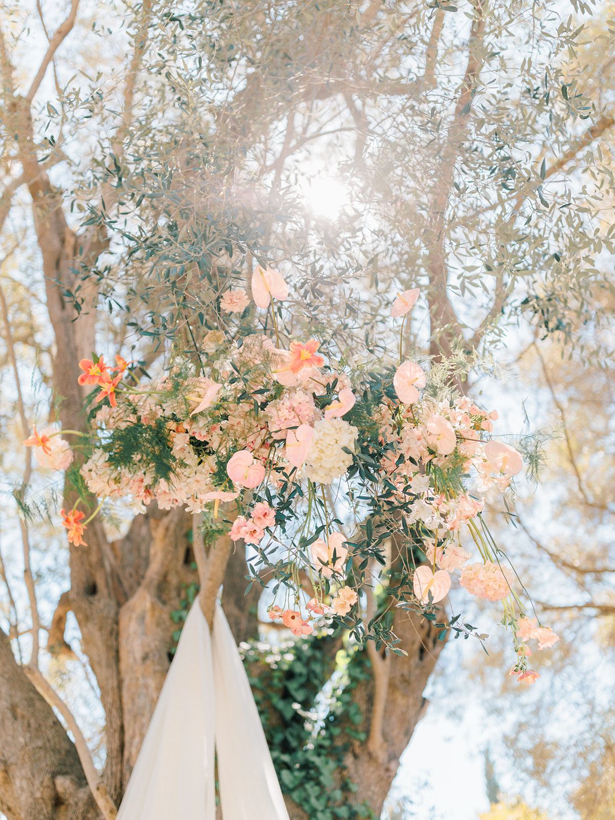 Peach and cream florals framing the ceremony arch