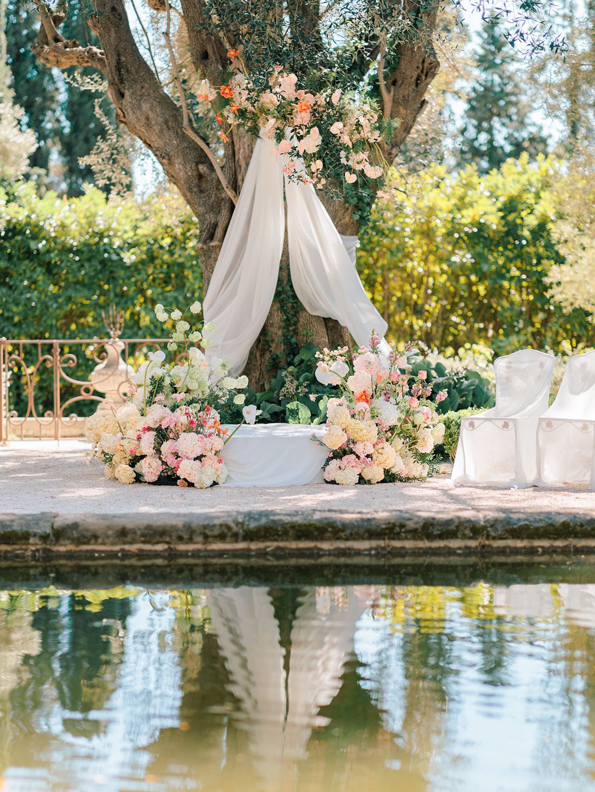 Draped altar and florals mirrored in the reflecting pool