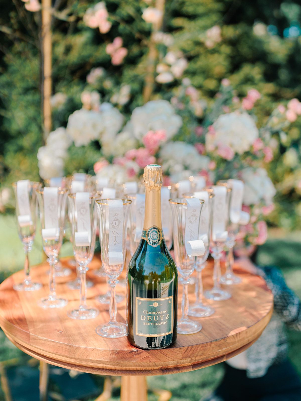 Champagne and coupes set out on a garden tray
