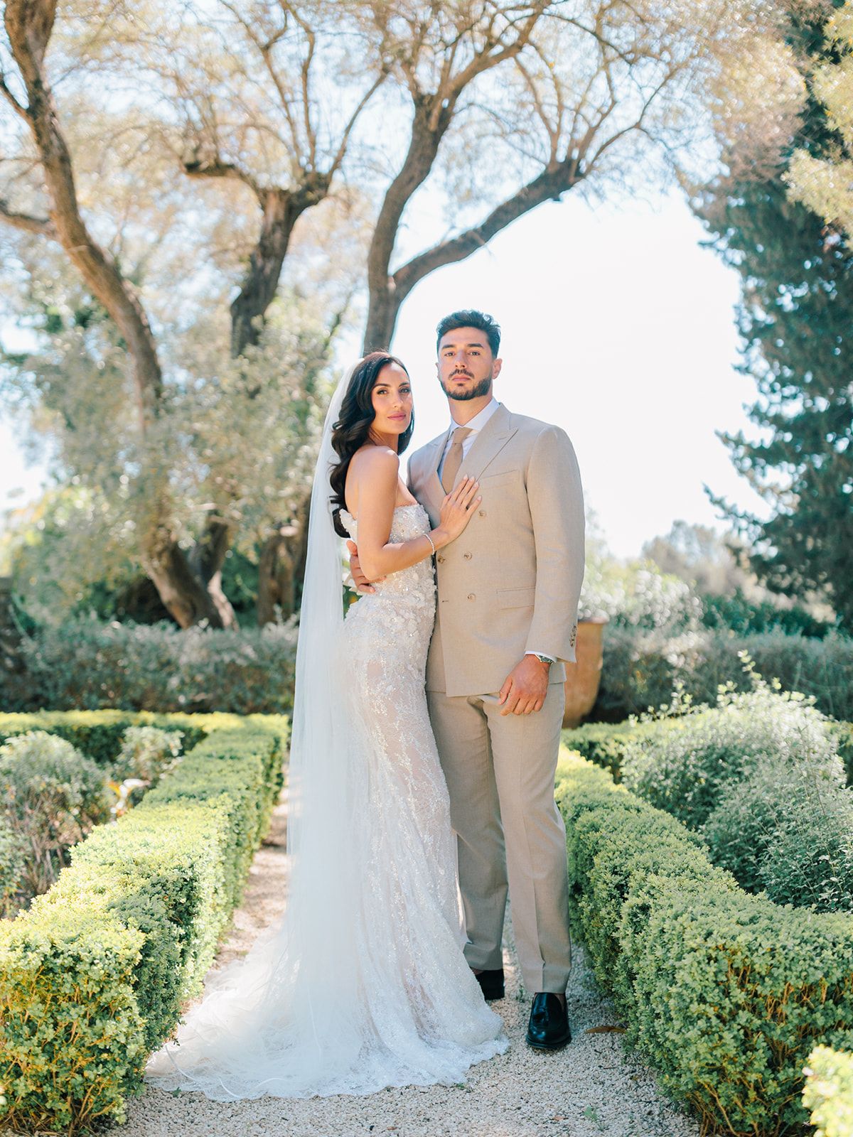 Bride and groom together in the garden walk