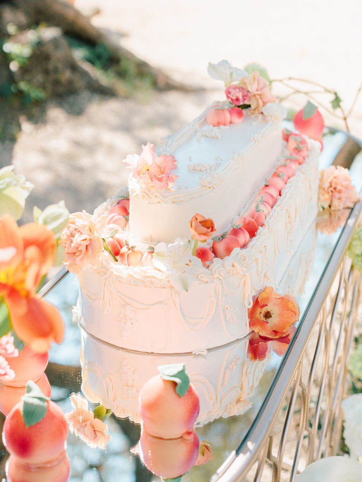 Tiered cake dressed with peach blooms