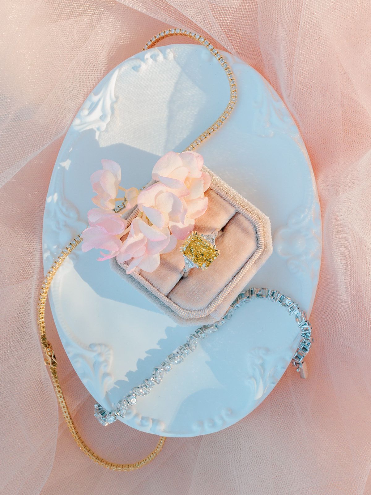 Ring box and jewellery set on pale blue silk