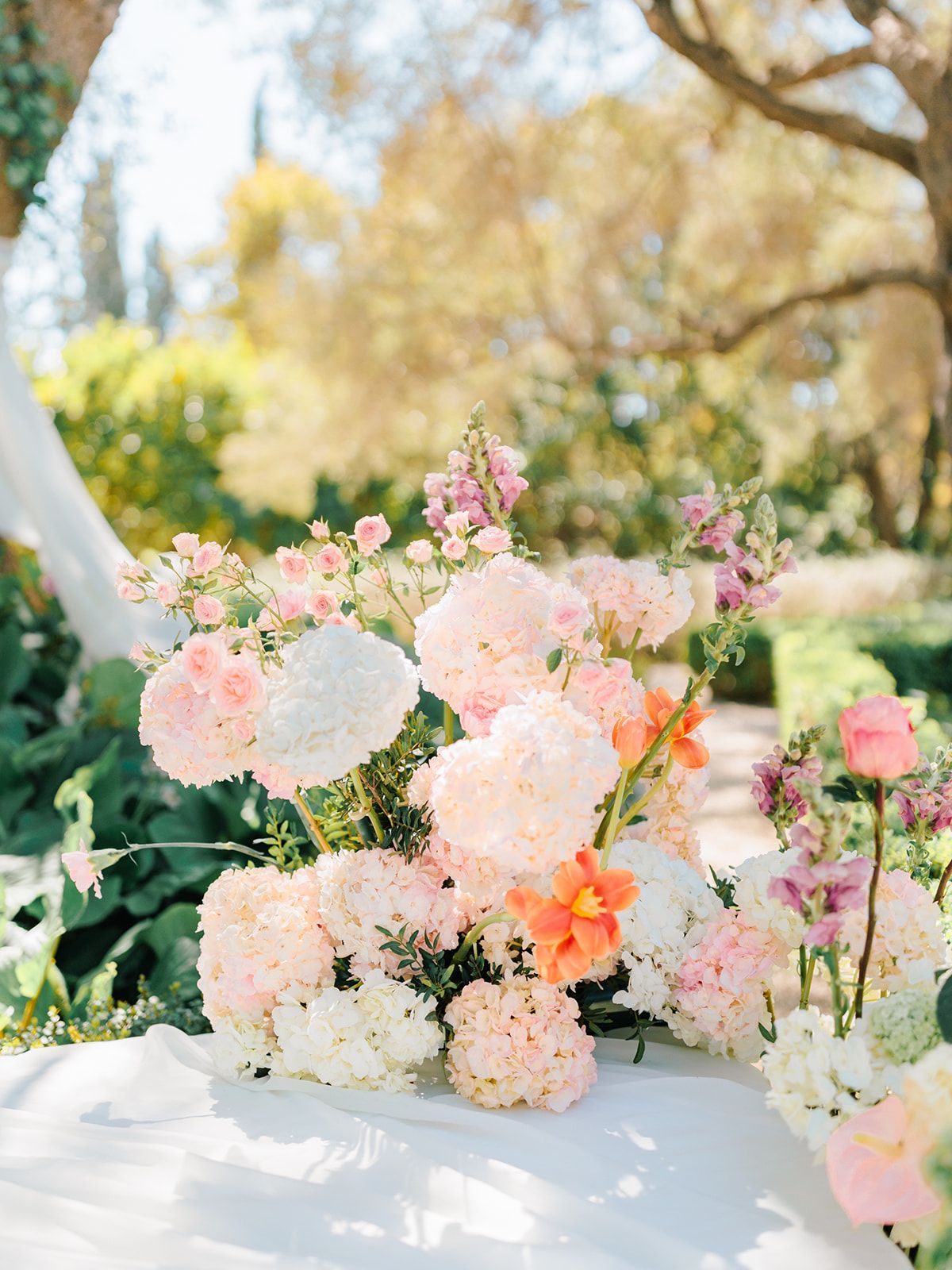Close detail of the peach, blush and cream ceremony florals