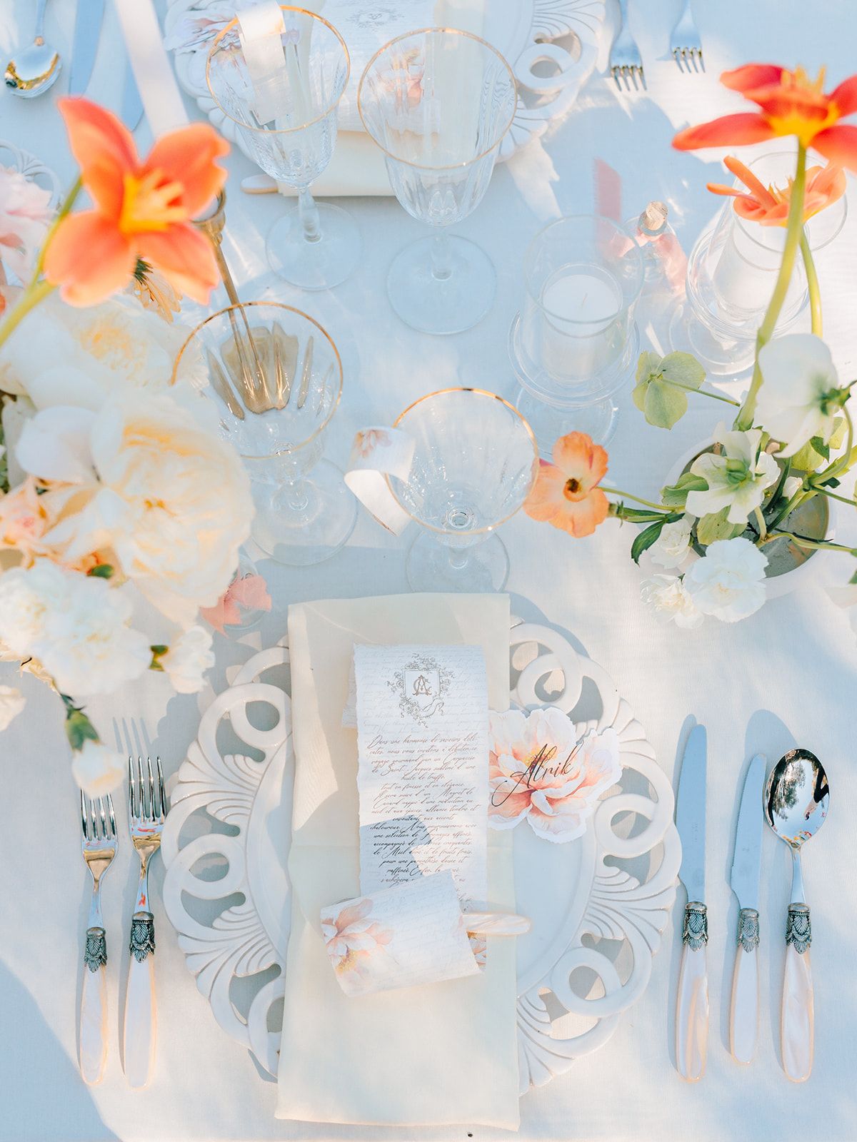 Place setting with lilies and painted stationery, from above