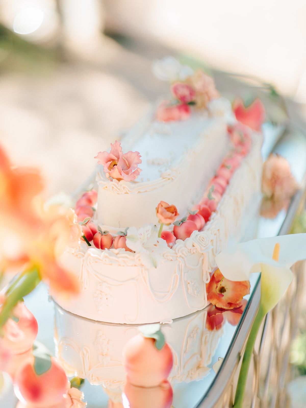 Cake dressed with coral and peach blooms