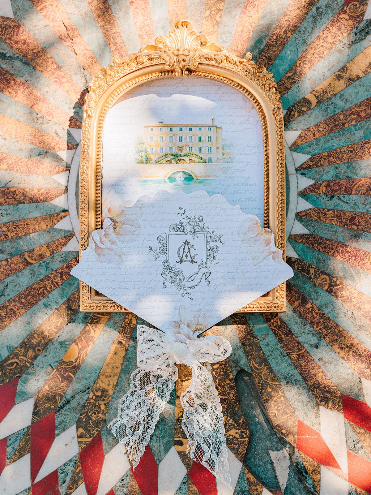 Gilt mirror, painted fan and stationery arranged as a flat lay