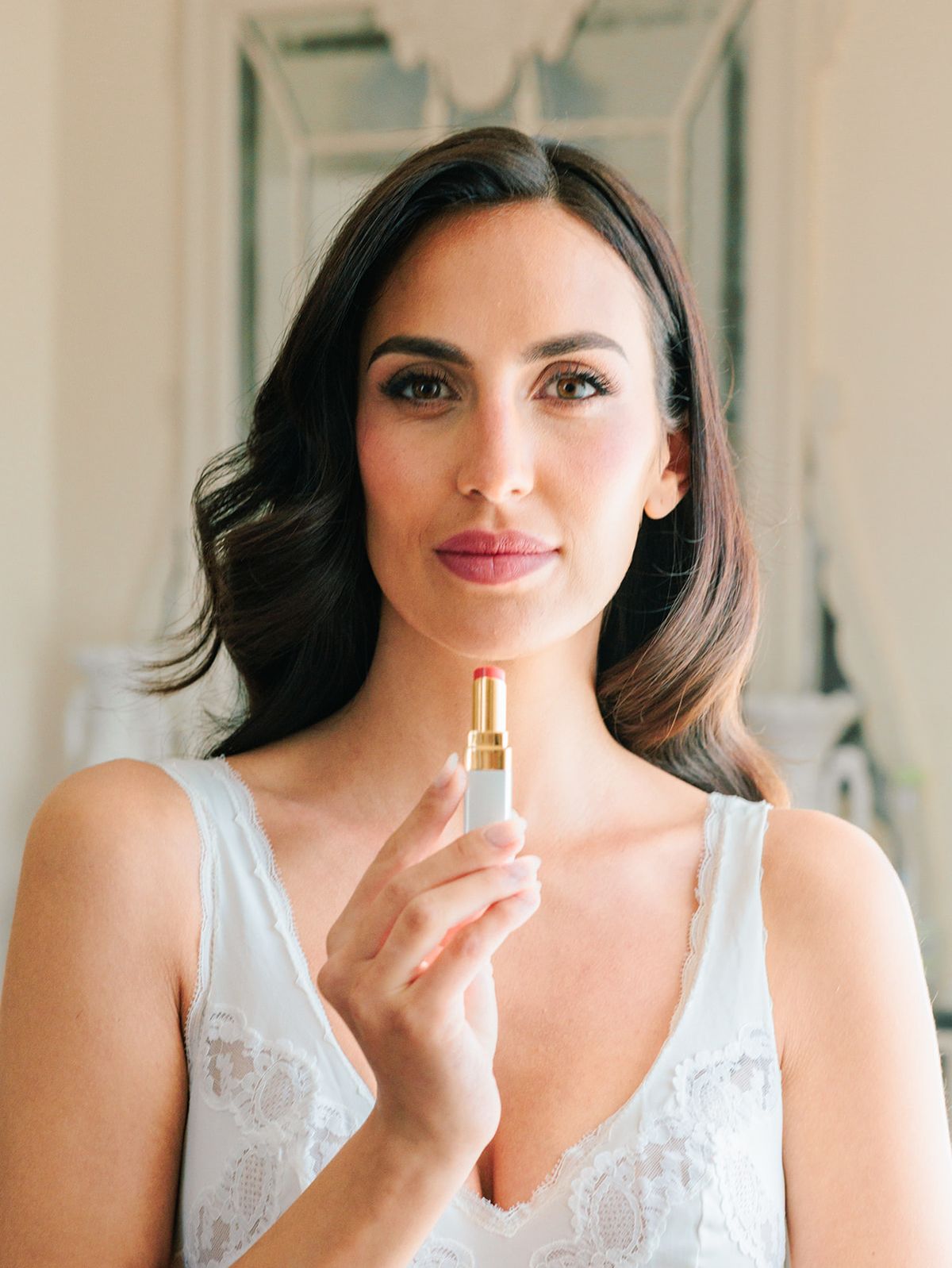 Bride with her perfume before dressing