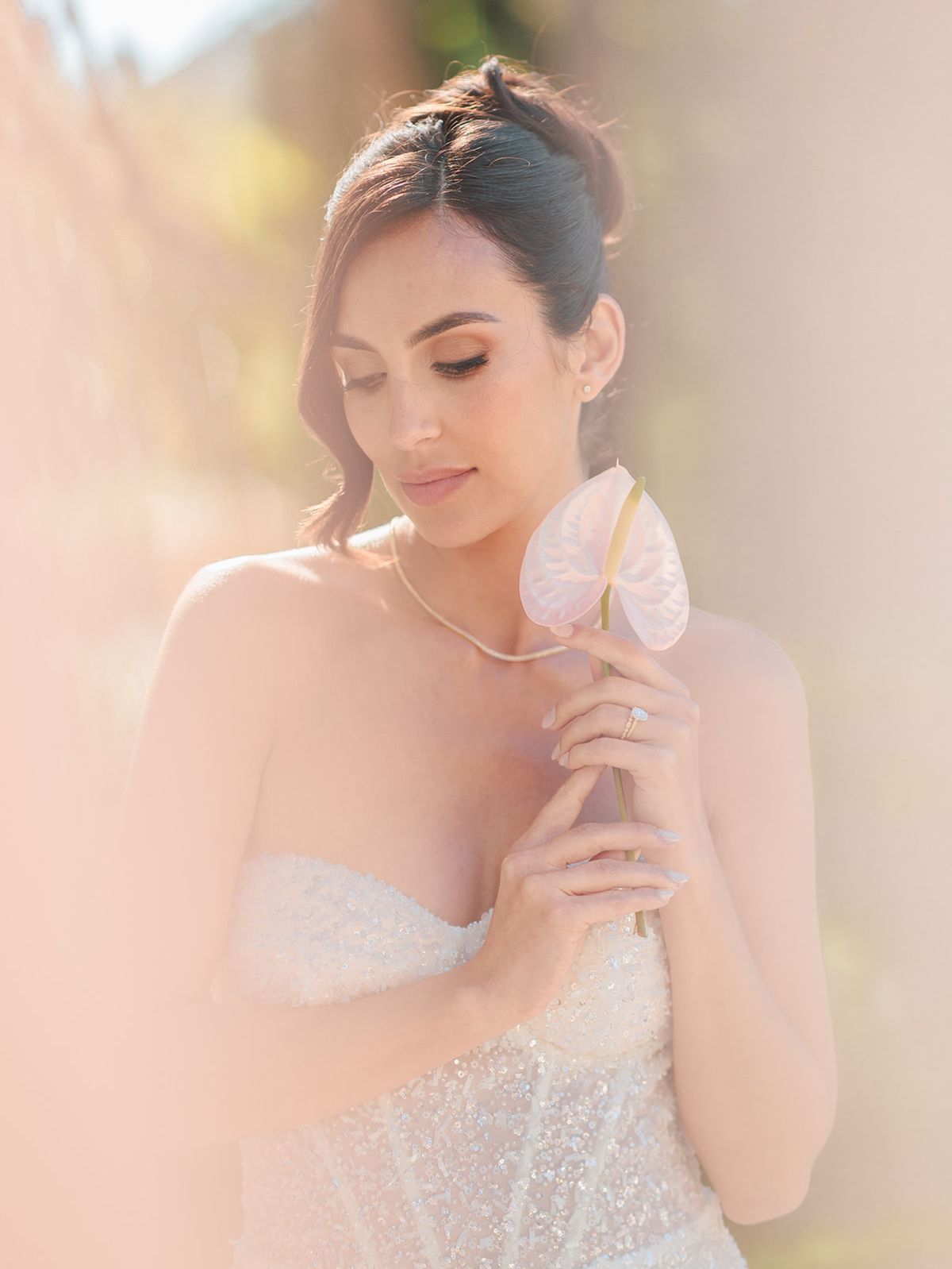 Bride with her hand at her shoulder