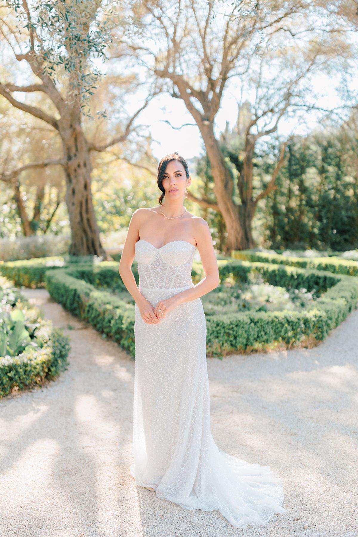 Bride standing in the formal garden