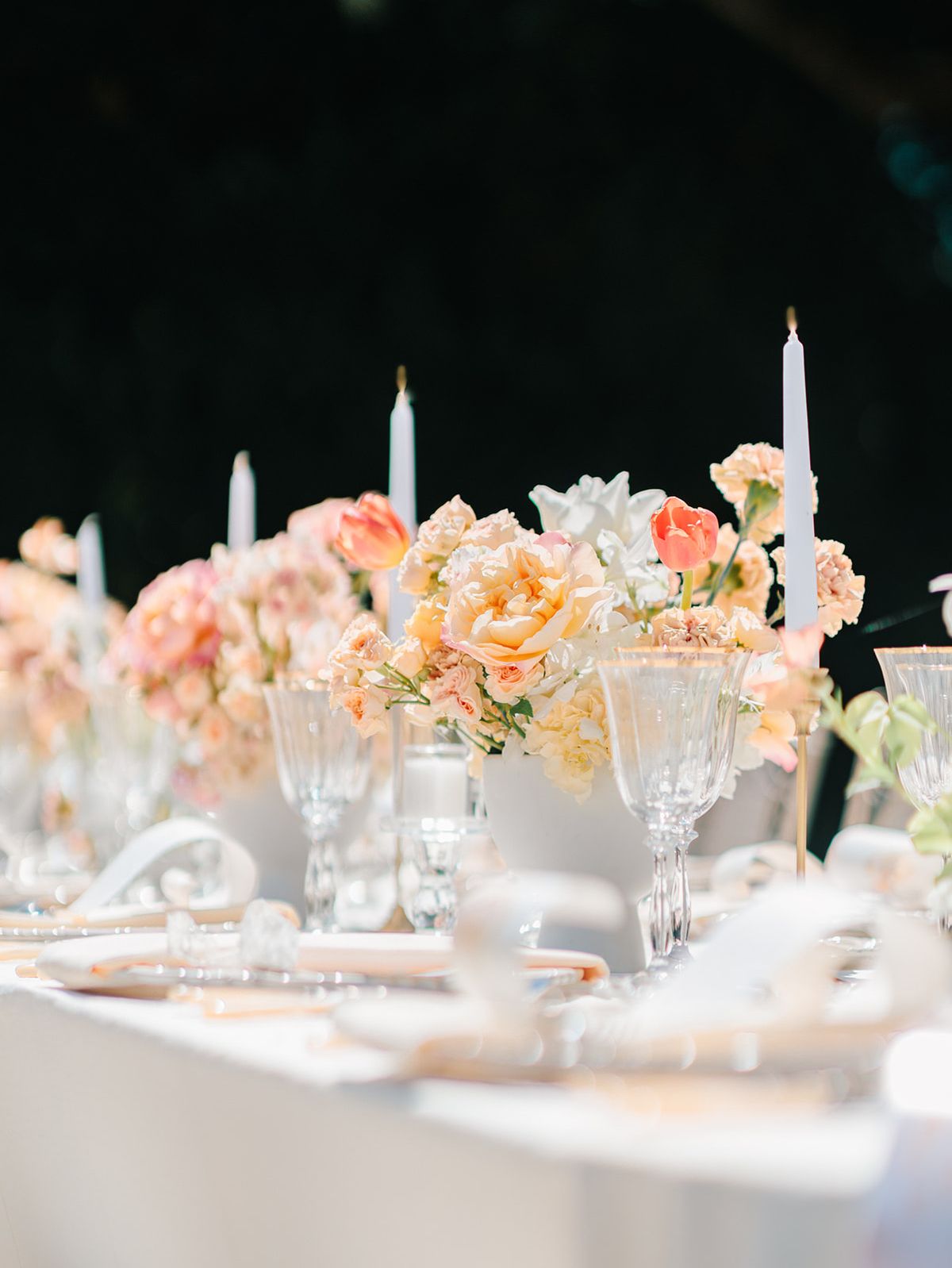 Tablescape with tapered candles and peach florals