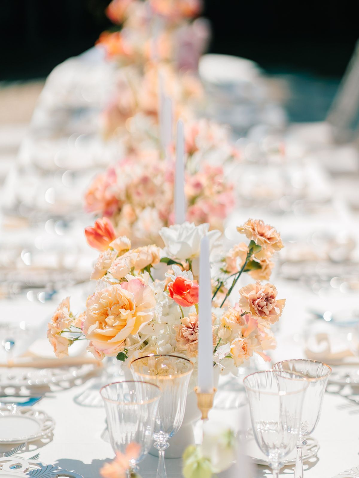 Reception table with candlelight and peach arrangements