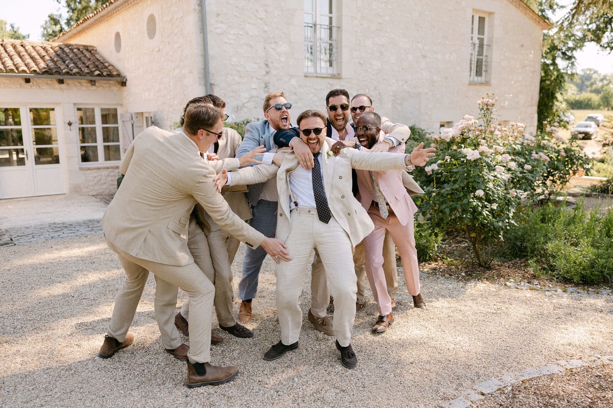 Groomsmen posing together in cream suits