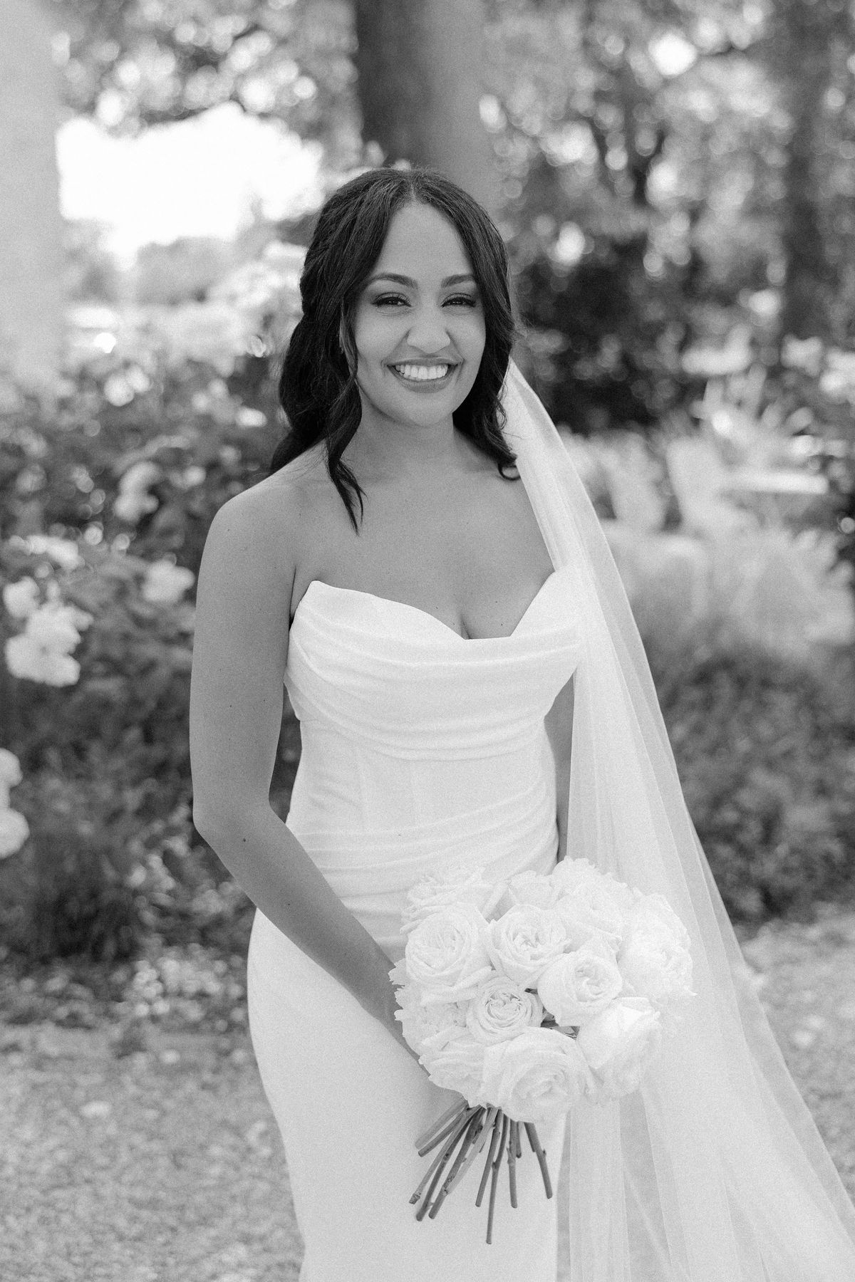 Black and white portrait of the bride holding her bouquet