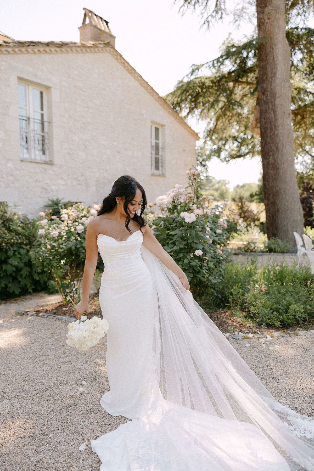 Bride walking alone through the garden