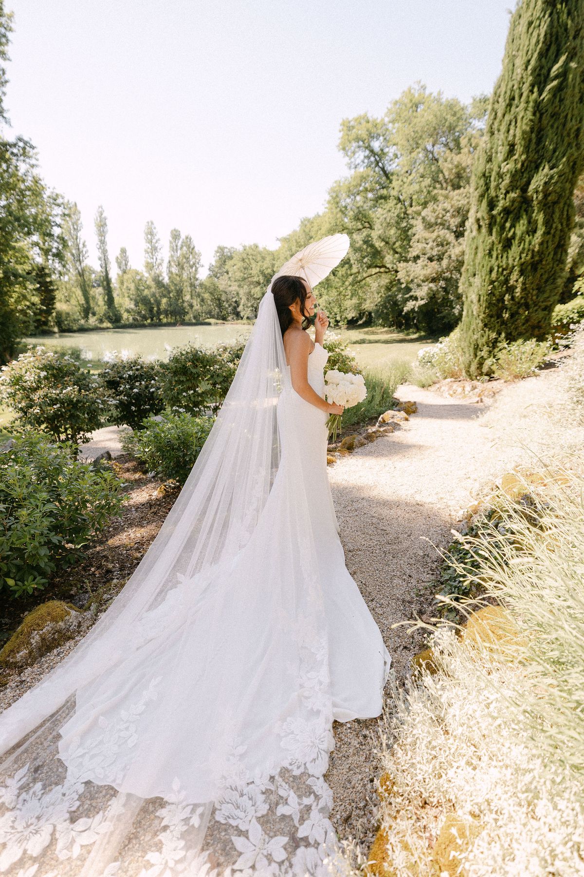 Bride walking alone along a gravel path
