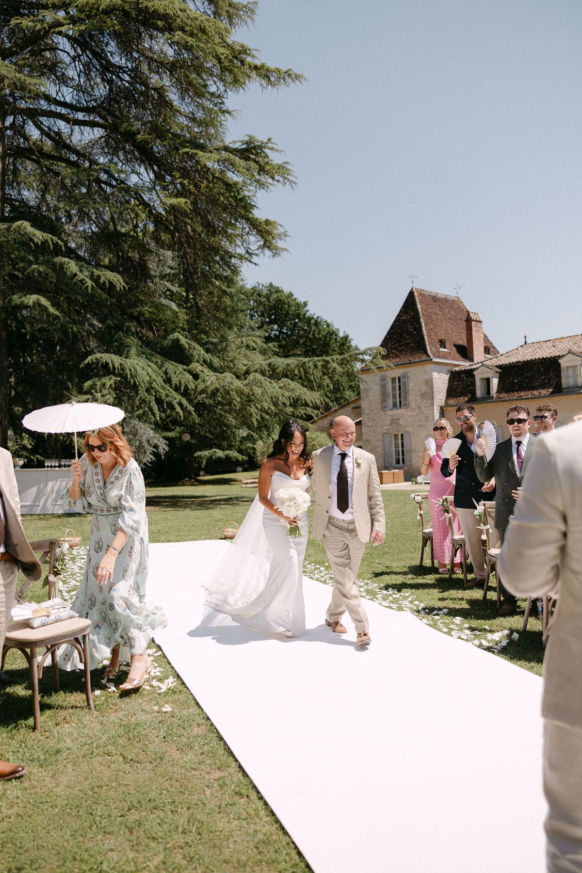 Newlyweds walking back down the aisle past guests