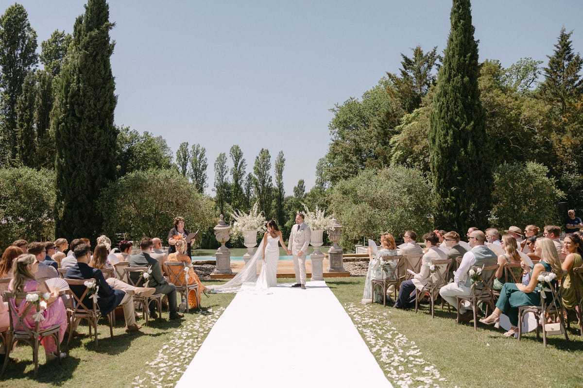 Wide shot of the confetti recessional down the aisle