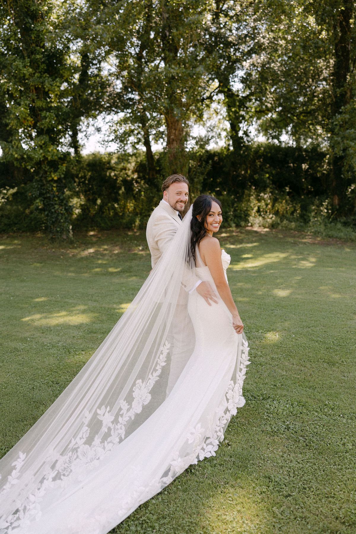 Bride and groom embracing on the open lawn