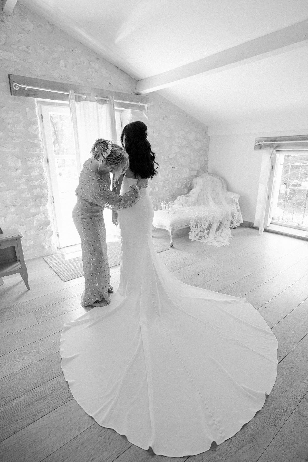 Bride being helped into her wedding gown