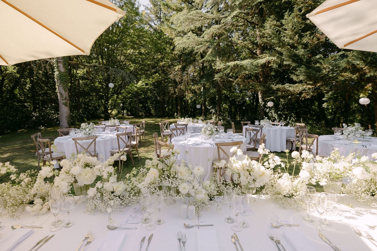 Long reception table dressed with white florals