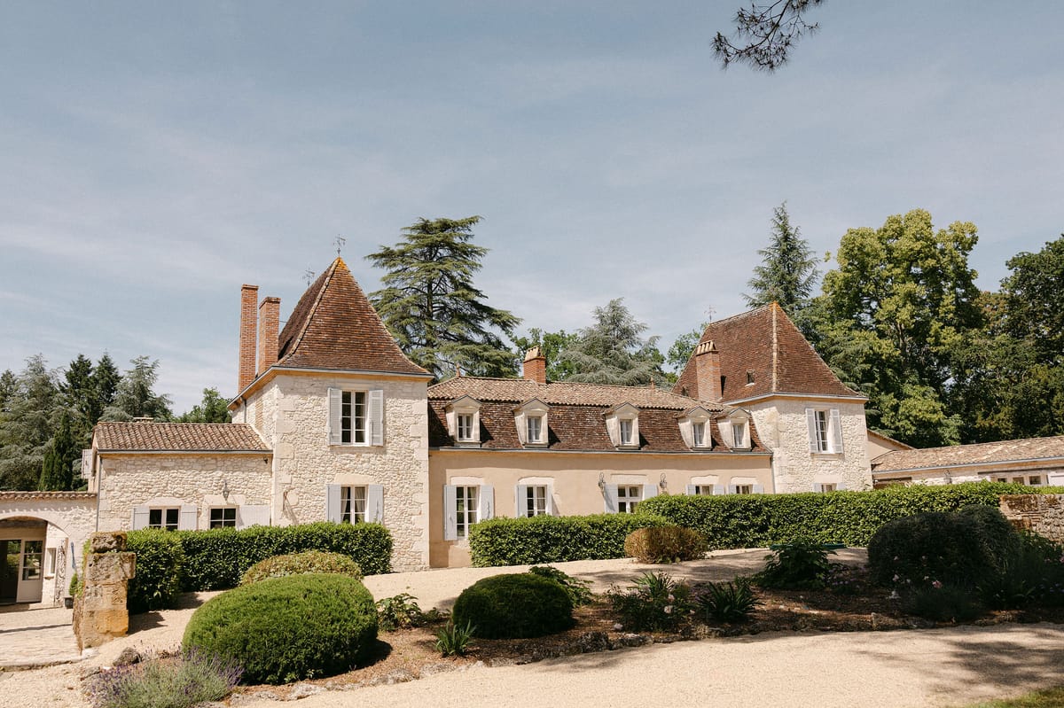 Château Lacanaud stone facade and manicured lawn, Dordogne, France