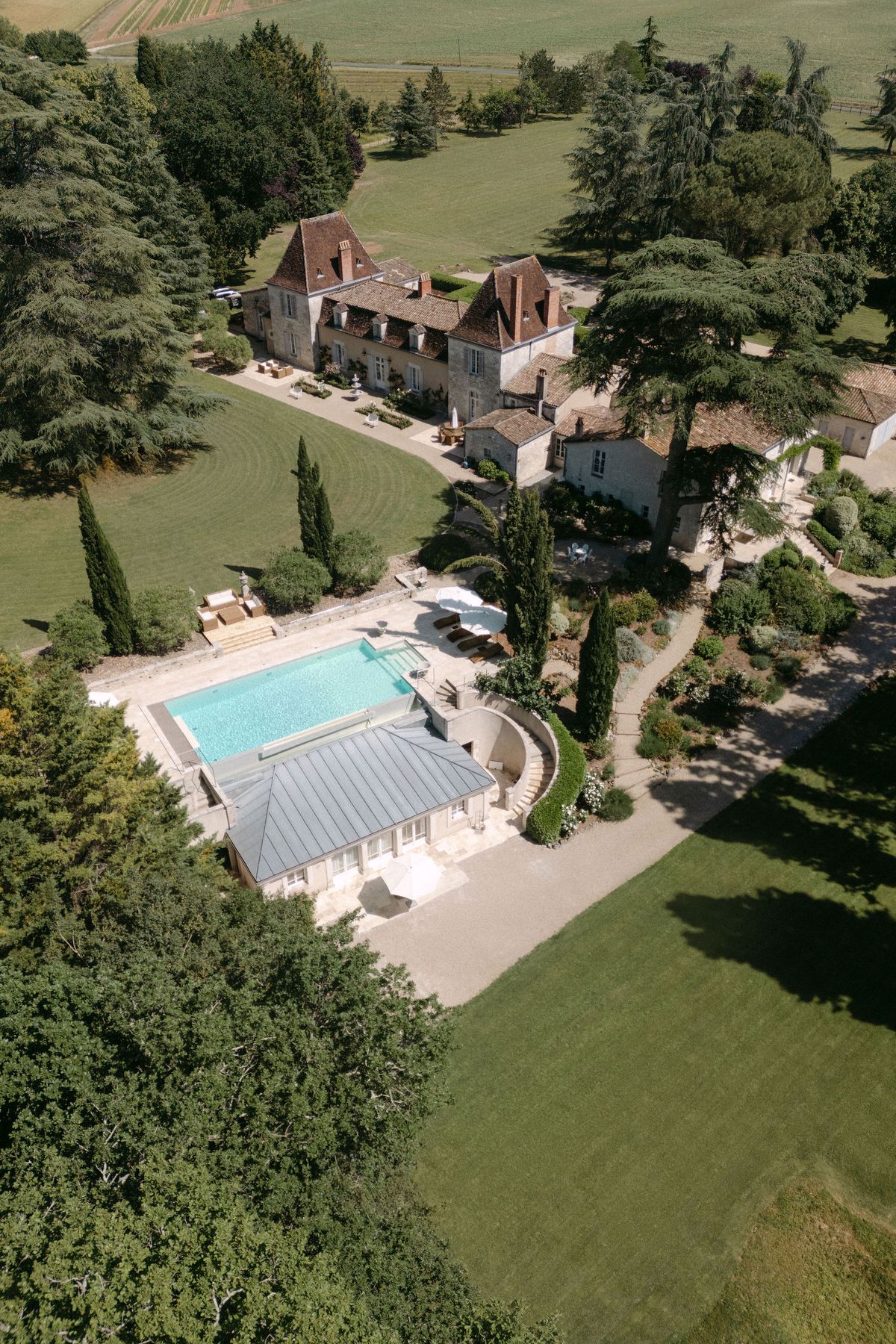Aerial view of Château Lacanaud's swimming pool and grounds