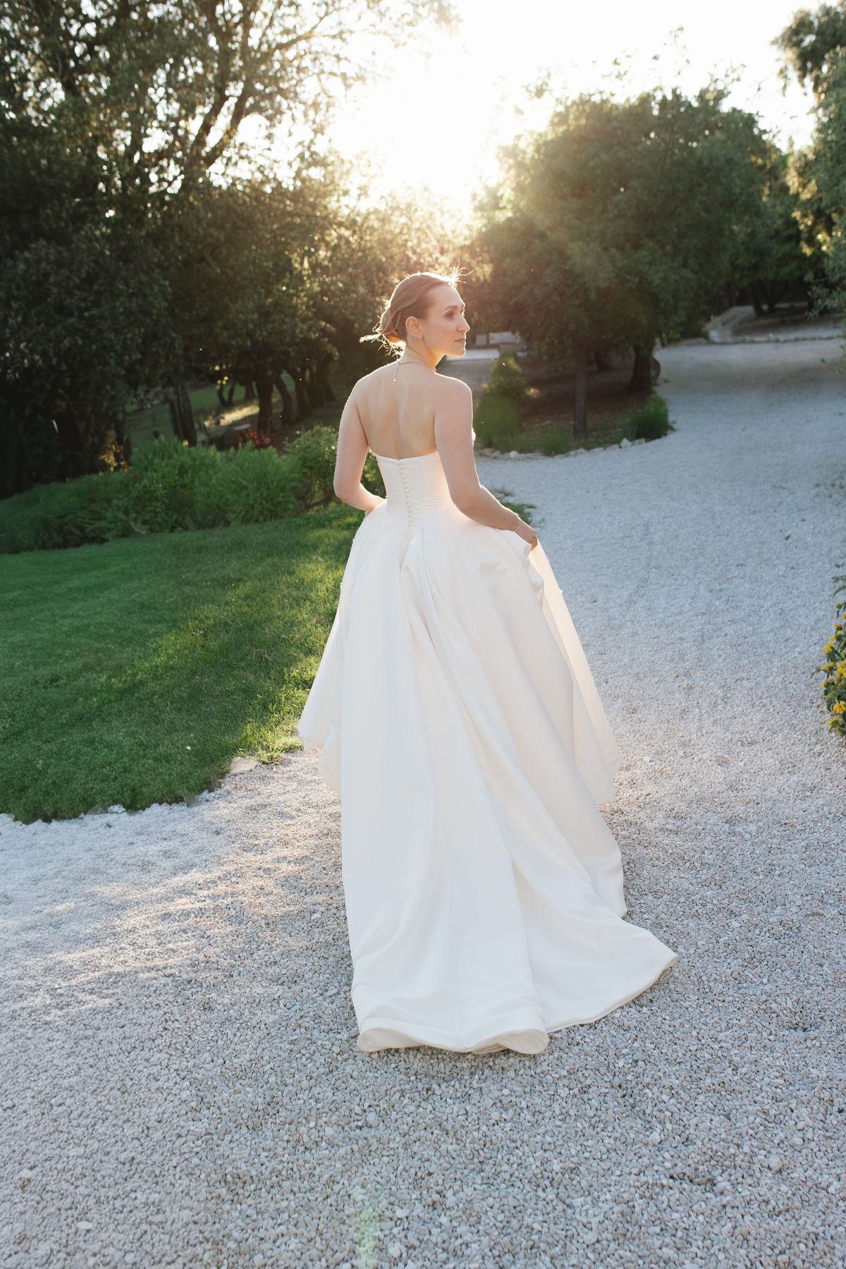 Bride from behind walking in her gown