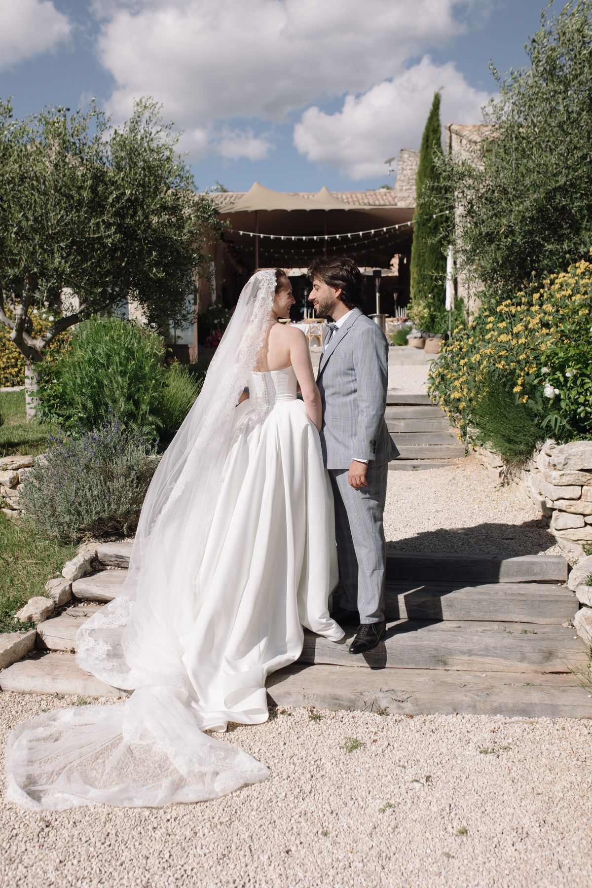 Bride and groom walking down stone steps together