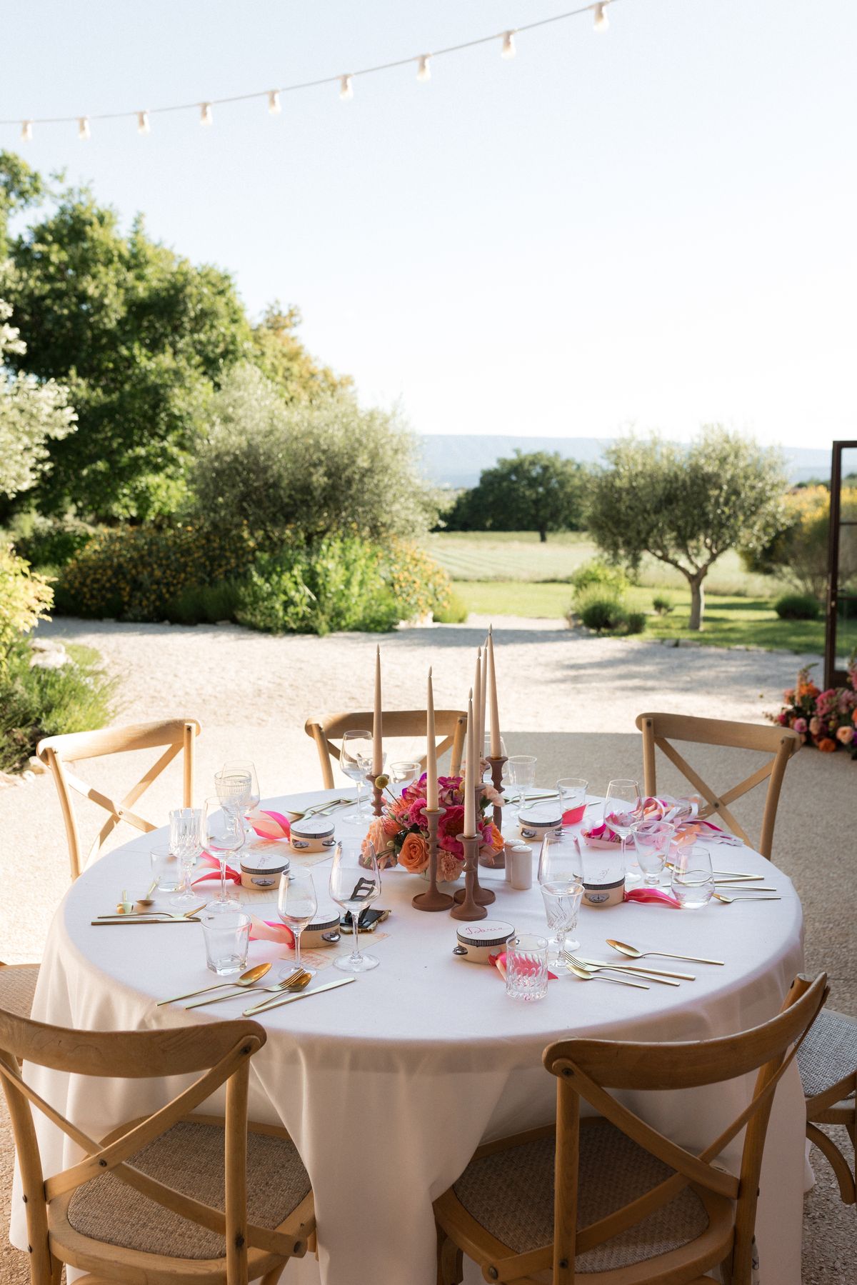 Table setting with tall candles overlooking the Provence countryside